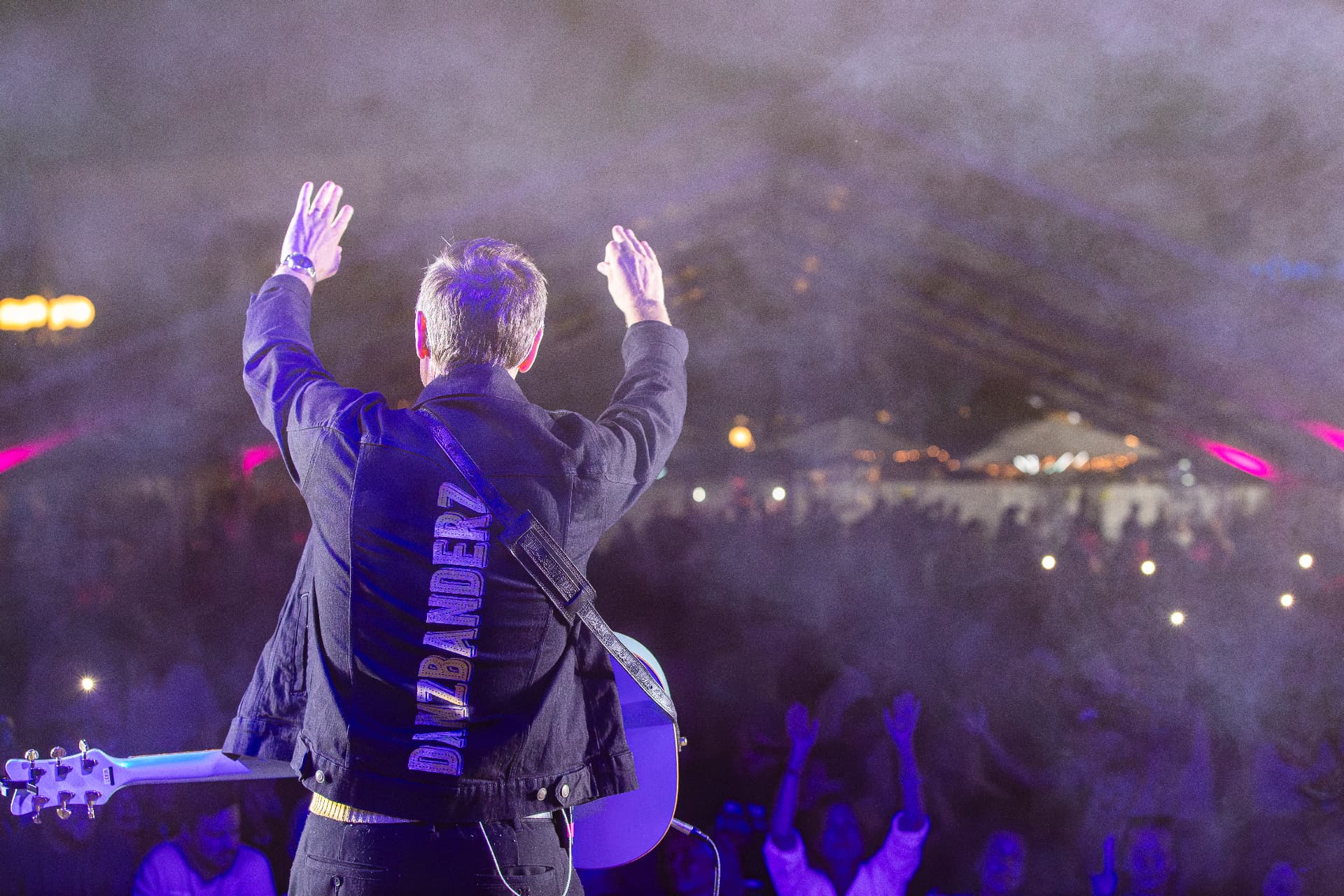 Linus Lindholm med händerna i luften framför festivalpubliken